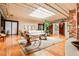 Open concept living area with hardwood floors, skylights, brick details, and comfortable seating at 1933 Mclendon Ne Ave # A, Atlanta, GA 30307