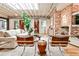 Open living room features hardwood floors, an exposed brick fireplace, white walls, and high ceilings at 1933 Mclendon Ne Ave # A, Atlanta, GA 30307