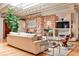 Stylish living area featuring a brick fireplace, hardwood floors, and ample natural light from large windows at 1933 Mclendon Ne Ave # A, Atlanta, GA 30307