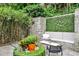 Outdoor patio area with stone benches, a seating area, and lush landscaping at 1933 Mclendon Ne Ave # A, Atlanta, GA 30307