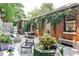 Lush backyard with patio seating, mature landscaping, and brick exterior at 1933 Mclendon Ne Ave # A, Atlanta, GA 30307