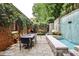 Private patio features a water feature, outdoor dining space, and mature landscaping at 1933 Mclendon Ne Ave # A, Atlanta, GA 30307