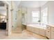 Bright bathroom boasts a soaking tub, glass shower, and vanity at 1975 River Forest Drive, Marietta, GA 30068