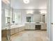 Bright bathroom boasts a soaking tub, glass shower, and dual vanity sinks at 1975 River Forest Drive, Marietta, GA 30068