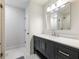 Bathroom features modern vanity with black cabinets and a frameless mirror at 1975 River Forest Drive, Marietta, GA 30068