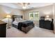 Bedroom with large window offering natural light, neutral walls and a ceiling fan at 1975 River Forest Drive, Marietta, GA 30068