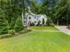 Beautiful home with lush greenery, expansive lawn, and charming architectural details on a sprawling lot at 1975 River Forest Drive, Marietta, GA 30068