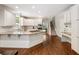Well-lit kitchen featuring white cabinets, granite countertops, a central island, and modern appliances at 1975 River Forest Drive, Marietta, GA 30068