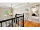 Upstairs landing with hardwood floors, chandelier, and views to the outside at 1975 River Forest Drive, Marietta, GA 30068