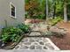 Stone walkway leading through landscaped yard with hydrangeas and retaining wall at 1975 River Forest Drive, Marietta, GA 30068