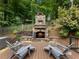 Outdoor stone fireplace and wooden seating area make great entertaining or relaxing space at 1975 River Forest Drive, Marietta, GA 30068