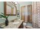Bathroom featuring granite counters, wood-look floors, and modern vanity at 1977 Wee Kirk Se Rd, Atlanta, GA 30316