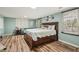 This bedroom has a full sitting area with a blue couch and a king bed with lots of pillows at 1977 Wee Kirk Se Rd, Atlanta, GA 30316