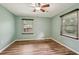 Bedroom with wood-look floors, light blue walls, and ceiling fan at 1977 Wee Kirk Se Rd, Atlanta, GA 30316