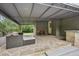 Inviting covered patio featuring stone flooring, comfortable seating, and a tranquil outdoor space at 1977 Wee Kirk Se Rd, Atlanta, GA 30316