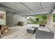 Well-appointed covered patio with flagstone flooring and comfortable seating is perfect for entertaining at 1977 Wee Kirk Se Rd, Atlanta, GA 30316