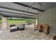 Relaxing covered patio with stone flooring, ample seating, and rustic decor for outdoor enjoyment at 1977 Wee Kirk Se Rd, Atlanta, GA 30316