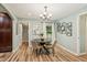 Dining room features a modern chandelier and an archway leading into the living room at 1977 Wee Kirk Se Rd, Atlanta, GA 30316
