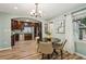 Open dining room with view into the kitchen with dark wood cabinets and stainless appliances at 1977 Wee Kirk Se Rd, Atlanta, GA 30316