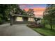 Charming single-story home with concrete driveway, blue front door and manicured landscaping at 1977 Wee Kirk Se Rd, Atlanta, GA 30316