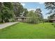 Charming single-story home featuring a well-manicured front lawn, mature trees, and a long driveway at 1977 Wee Kirk Se Rd, Atlanta, GA 30316