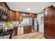 Well-lit kitchen with stainless steel appliances, granite counters, and wood floors at 1977 Wee Kirk Se Rd, Atlanta, GA 30316
