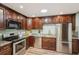 The kitchen features stainless steel appliances, granite countertops, and dark wood cabinets at 1977 Wee Kirk Se Rd, Atlanta, GA 30316