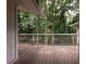 Back deck showcasing wooden planks and railings surrounded by lush trees for privacy at 4135 Sunrise Trail, Atlanta, GA 30349