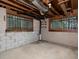 Unfinished basement with cement flooring and block walls, with a window offering natural light at 4135 Sunrise Trail, Atlanta, GA 30349