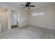 Spacious bedroom featuring a large window, ceiling fan, and ensuite access to the bathroom at 4135 Sunrise Trail, Atlanta, GA 30349