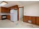 Spacious kitchen with wood cabinets, laminate countertops, and a view into the unfinished living space at 4135 Sunrise Trail, Atlanta, GA 30349