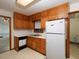 Galley kitchen featuring wood cabinets, updated laminate countertops, and double basin stainless steel sink at 4135 Sunrise Trail, Atlanta, GA 30349