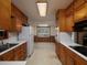 Functional kitchen with wood cabinets, white appliances, and a window overlooking the backyard, ready for your personal touch at 4135 Sunrise Trail, Atlanta, GA 30349