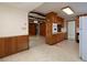 Open kitchen and dining area with wood cabinets and adjacent sitting room, ideal for entertaining at 4135 Sunrise Trail, Atlanta, GA 30349