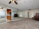 Expansive living room features mirrored wall, seamlessly connecting to the kitchen area for open-concept living at 4135 Sunrise Trail, Atlanta, GA 30349
