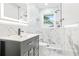 Modern bathroom featuring marble-style tile, a sleek vanity, illuminated mirror, and a luxurious shower system at 4188 Fontana Ct, Tucker, GA 30084