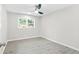 Sunlit bedroom with neutral walls, wood-look flooring, and a window offering a pleasant outdoor view at 4188 Fontana Ct, Tucker, GA 30084