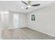 Bright bedroom with wood-look floors, a modern ceiling fan and an ensuite bathroom featuring marble-style tile at 4188 Fontana Ct, Tucker, GA 30084