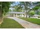 Quaint one-story home boasts a white exterior, lush green lawn, and a convenient covered carport at 4188 Fontana Ct, Tucker, GA 30084