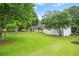 Charming one-story home with white painted brick and a lush, green front yard at 4188 Fontana Ct, Atlanta, GA 30084