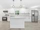 Modern kitchen featuring white cabinets, stainless steel appliances, granite countertops, and stylish pendant lighting at 4188 Fontana Ct, Tucker, GA 30084