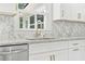 Kitchen features granite countertops, white cabinets with gold hardware, and a window above the sink at 4188 Fontana Ct, Tucker, GA 30084