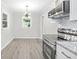 Bright kitchen features stainless steel appliances, granite counters, and an adjacent dining area with modern light fixture at 4188 Fontana Ct, Tucker, GA 30084