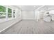 Bright, open-concept living area features modern gray floors, large windows, and seamless flow into the kitchen at 4188 Fontana Ct, Tucker, GA 30084