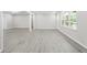 Spacious open floorplan features gray floors, fresh white walls, and a doorway leading to other rooms in the home at 4188 Fontana Ct, Tucker, GA 30084