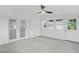 Covered sunroom featuring light gray tile flooring, whitewashed brick walls, and French doors at 4188 Fontana Ct, Tucker, GA 30084