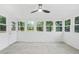 Bright sunroom filled with windows, tiled floor, shiplap walls and ceiling fan at 4188 Fontana Ct, Tucker, GA 30084