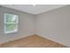 Bright bedroom featuring hardwood floors and a large window at 1095 Lyndhurst Way, Roswell, GA 30075