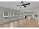 Spacious living room with large windows offering natural light and hardwood floors with open layout to the kitchen at 1095 Lyndhurst Way, Roswell, GA 30075