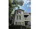 Multi-level condo building with gray siding, large windows, and balconies on a sunny day at 2107 Augusta Se Dr, Marietta, GA 30067